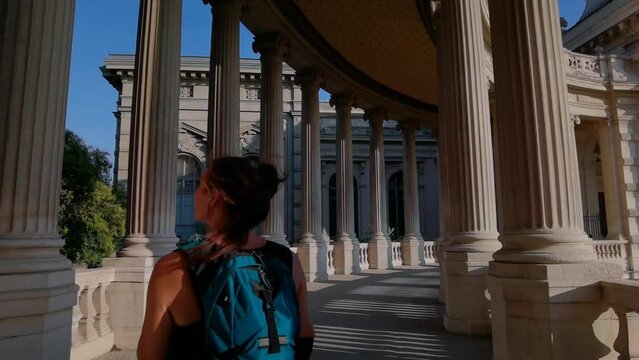 tourist girl walking in the Longchamp Palace looking around