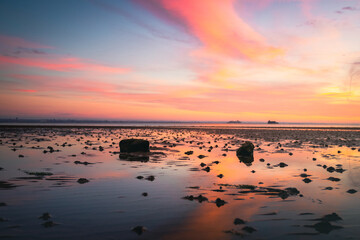 Fototapeta na wymiar A stunning sunset in the sky on a beach
