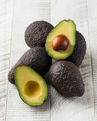 Ripe avocados on a white wooden background. healthy eating