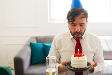 Attractive man looking sad and alone on his birthday