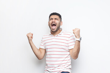 Portrait of extremely happy joyful cheerful bearded man wearing striped t-shirt standing with...