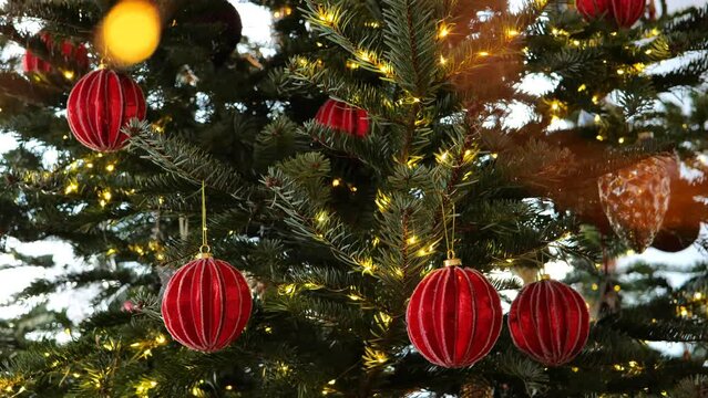 Christmas wallpaper. fir tree, red balls and shining garland.Holiday garlands bokeh background. 4k footage