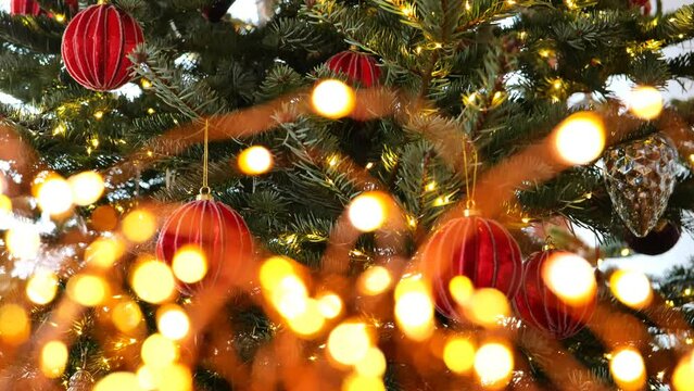 Christmas tree, red balls and shining garland.Christmas wallpaper. Holiday garlands bokeh background.4k footage