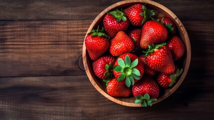strawberries in a bowl on a wooden table