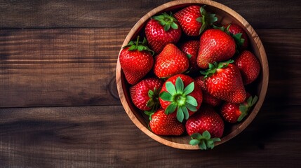 strawberries in a bowl on a wooden table