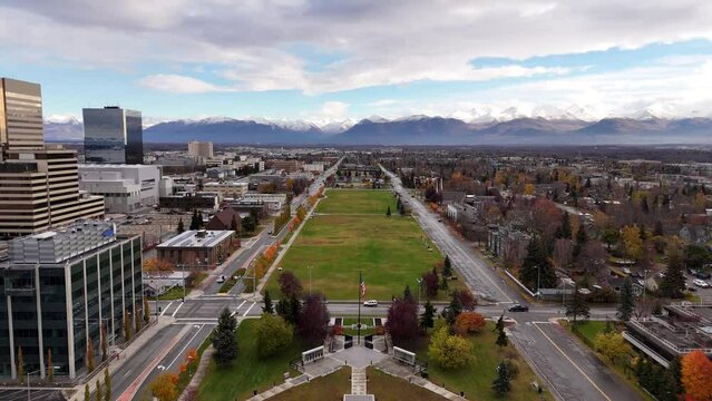 Downtown Anchorage, Alaska on autumn day with mountains in distance - Aerial 4K drone footage