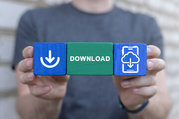 Man holding colorful blocks sees word: DOWNLOAD. Concept of Download Data Storage Business Web Technology. Downloading.