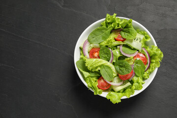 Delicious vegetable salad on grey table, top view. Space for text