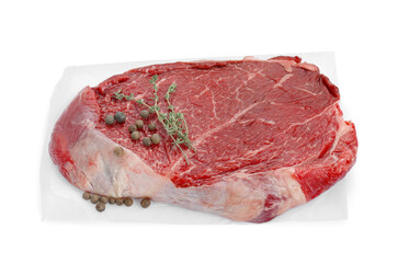 Piece of raw beef meat, peppercorns and thyme isolated on white