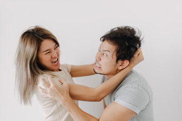 Funny angry face asian couple mad and fight at each other isolated on white.