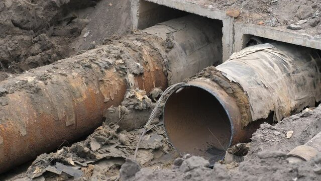 Reconstruction of heating pipe underground. Insulated steel pipeline in deep trench rust rusted. Reconstruction or replacement