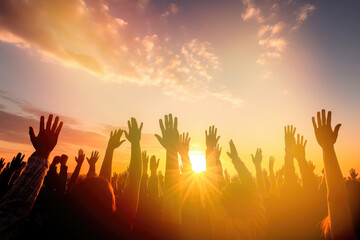Hands to heaven, group of people with their hands up looking at the sunset	