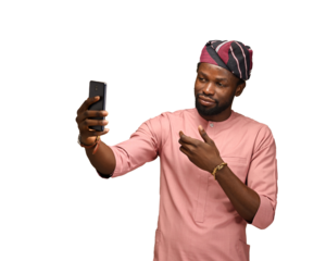 png of a Smiling young African American man guy in top and fila isolated on brown blue wall background. People lifestyle concept. copy space. Doing a selfie shot on a mobile phone showing thumb up