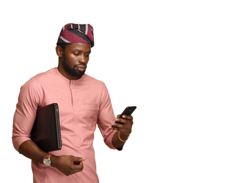 Png Photo of a Professional black African business male executive checking his phone carrying a laptop under his arm. Side view. Close-up portrait isolated on a brown background.
