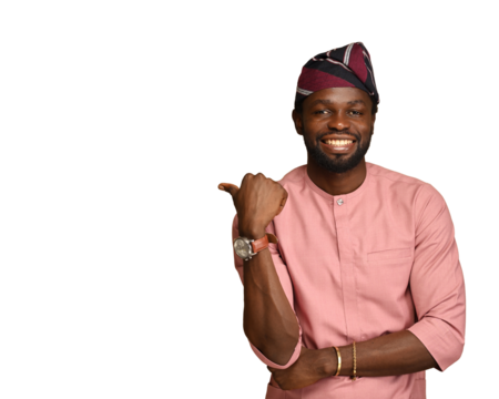 PNG of African businessman pointing finger away with a toothy smile on his face, empty space for your advertisement, wearing native style attires. Indoor studio shot isolated on brown background.