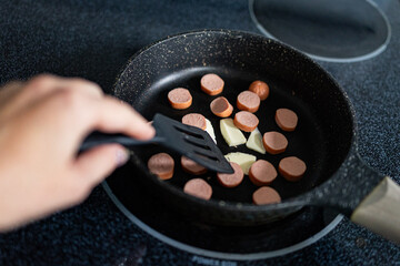 frying eggs and sausage