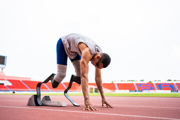 Asian para-athletes disabled with prosthetic blades running at stadium. 