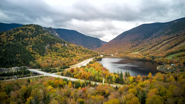 Timelapse of Echo Lake valley in New Hampshire, between Mount Lafayette on the left and Cannon mountain on the right with fall foliage colors