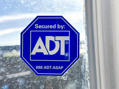 Calgary, Alberta, Canada. Oct 15, 2023. An ADT security sign on a window.