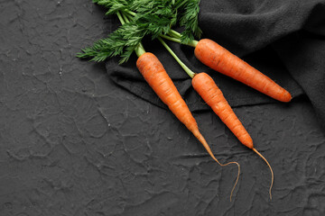 Fresh carrots on black background - obrazy, fototapety, plakaty