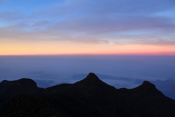 The three cone shape mountains and sunrise sky at Adam's Peak, Sri Lanka