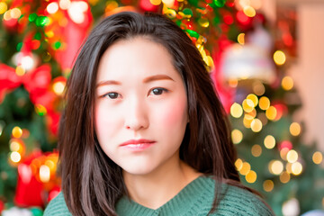 Christmas portrait of a Japanese woman in a green jumper