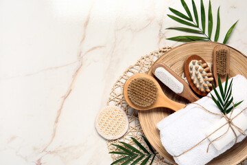 Composition with different bath supplies and palm leaves on light background
