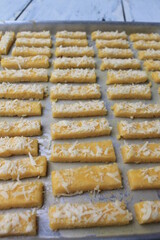 Rows of Indonesian cakes called kastangel on a table ready to bake