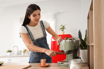 Young woman making coffee in kitchen