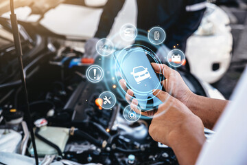 Mechanic using smart phone checking up on car engines parts for fixing and repair, Smart service...