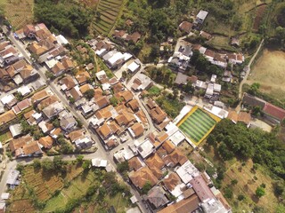 Fototapeta premium Drone Photography. Top down view of a small village and trees in a remote part of Manglayang Mount, Bandung - Indonesia. A remote settlement located at the top of a mountain