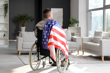 Young soldier in wheelchair at home, back view. Veterans Day celebration