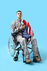 Fototapeta na wymiar Young soldier in wheelchair with USA flag on blue background. Veterans Day celebration