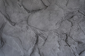 The gray texture of the stone. The cracked layered surface of the mountain. Close-up. Grey stone background with space to copy. High quality photo
