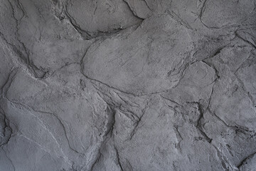 The gray texture of the stone. The cracked layered surface of the mountain. Close-up. Grey stone background with space to copy. High quality photo