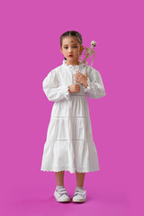 Little girl dressed for Halloween with skeleton on purple background