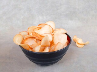 Cassava chips in a bowl. Cassava chips served in a bowl. Traditional snack made from thinly sliced ​​cassava and then fried. snacks to accompany your time relaxing or watching TV shows. Keripik