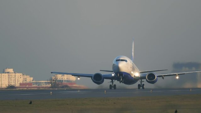 Airplane or aircraft taking off (takes off) at sunset or dawn
