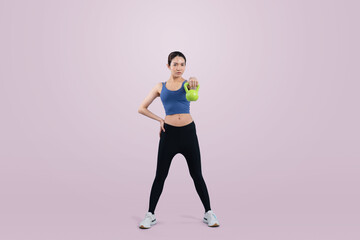Fototapeta na wymiar Vigorous energetic woman doing kettlebell weight lifting exercise on isolated background. Young athletic asian woman strength and endurance training session as body workout routine.