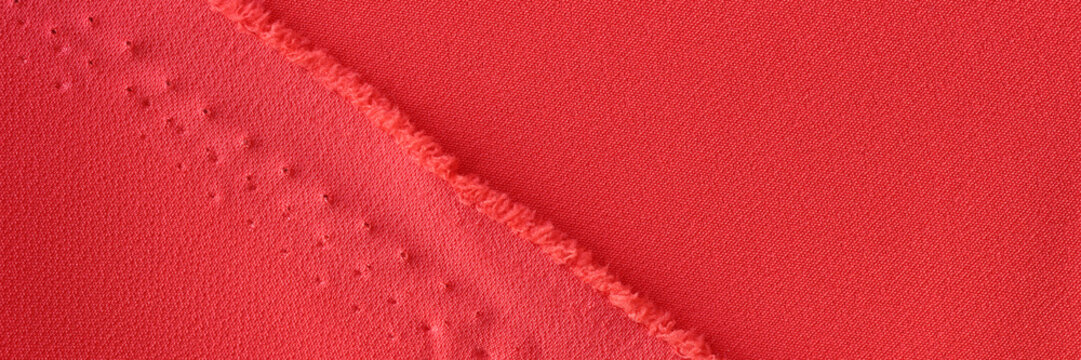 Straight neat undone seam of bright red fabric for clothes
