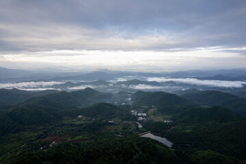 Top view Landscape of Morning Mist with Mountain Layer at north of Thailand. mountain ridge and clouds in rural jungle bush forest
