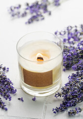 Obraz na płótnie Canvas Aroma Candle. Lavender candle on a white tile background.