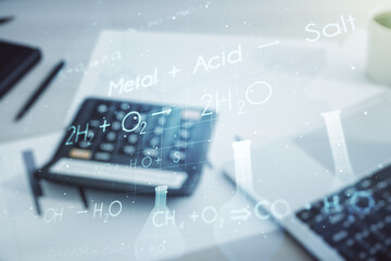 Double exposure of abstract virtual chemistry hologram on blurry calculator with laptop background,...