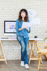 Asian professional successful young female creative graphic designer in casual fashionable denim...