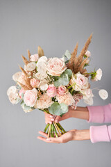 Small Beautiful bouquets of mixed flowers in woman hand. Floral shop concept . Beautiful fresh cut bouquet. Flowers delivery