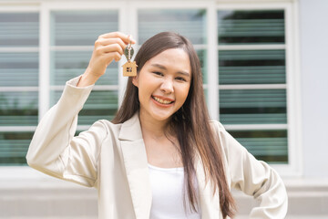 New home owner, happy family asian young woman smile holding, cheerful girl showing apartment house key. Banker agreement mortgage loan purchase buy, property lease real estate for relocation