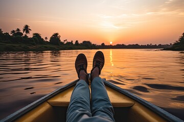 Close up of man's feet in boat on the river at sunset, Crop unrecognizable barefooted male traveler sitting on edge of boat during cruise on rippling nile river against cloudless, AI Generated - Powered by Adobe