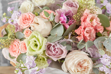 Small Beautiful bouquet of mixed flowers in woman hand. Floral shop concept . Beautiful fresh cut bouquet. Flowers delivery