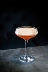 side view of tropical cocktail with foam in a martini glass