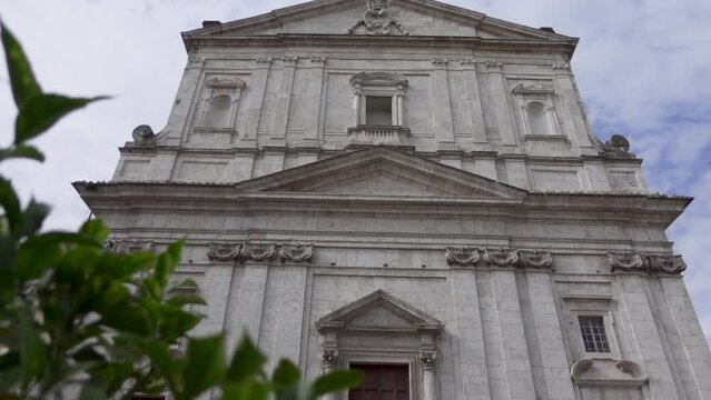 Stone fa&ccedil;ade of the church San Filippo Neri with varied tympani over doors and windows and Corinthian pilasters. Location : Spoleto, an Umbrian city in central Italy.